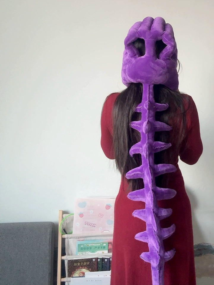 Funny plush dinosaur skull hood accessory inspired by cozy TikTok fashion trends