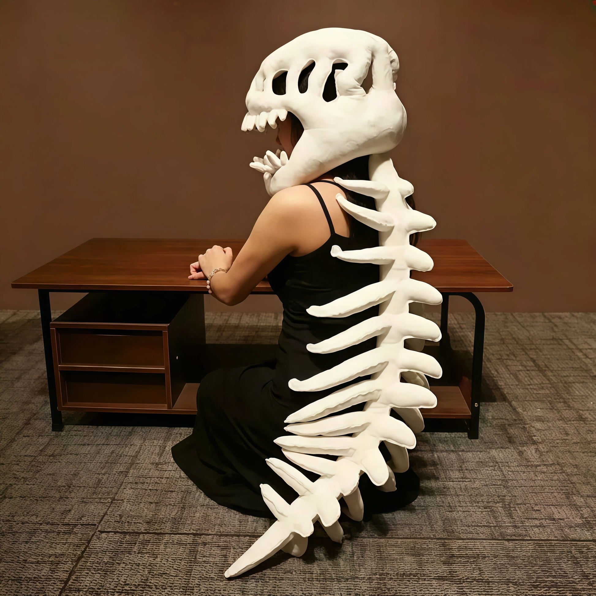 Person wearing oversized dinosaur skull plush headpiece creating viral TikTok content