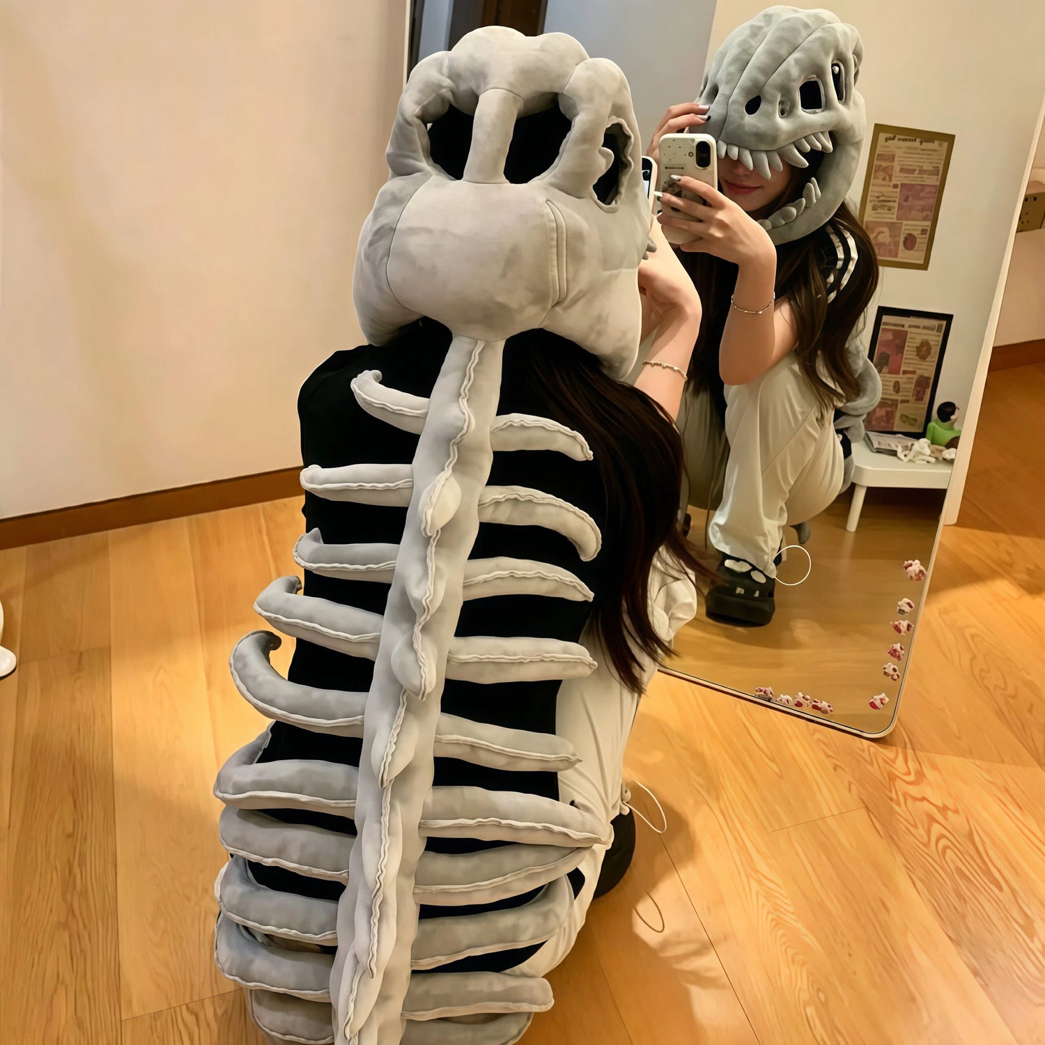 Adult wearing soft plush dinosaur skull costume accessory indoors